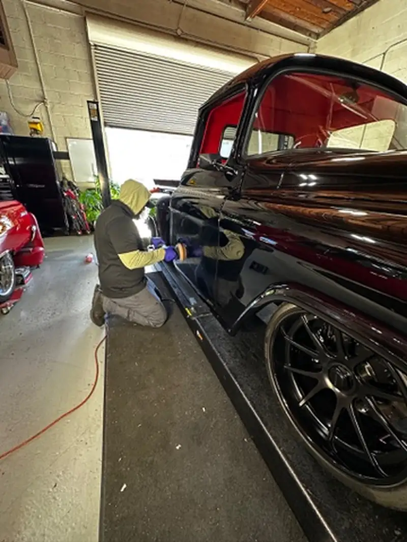 Machine polishing the paint on a classic truck before ceramic coating